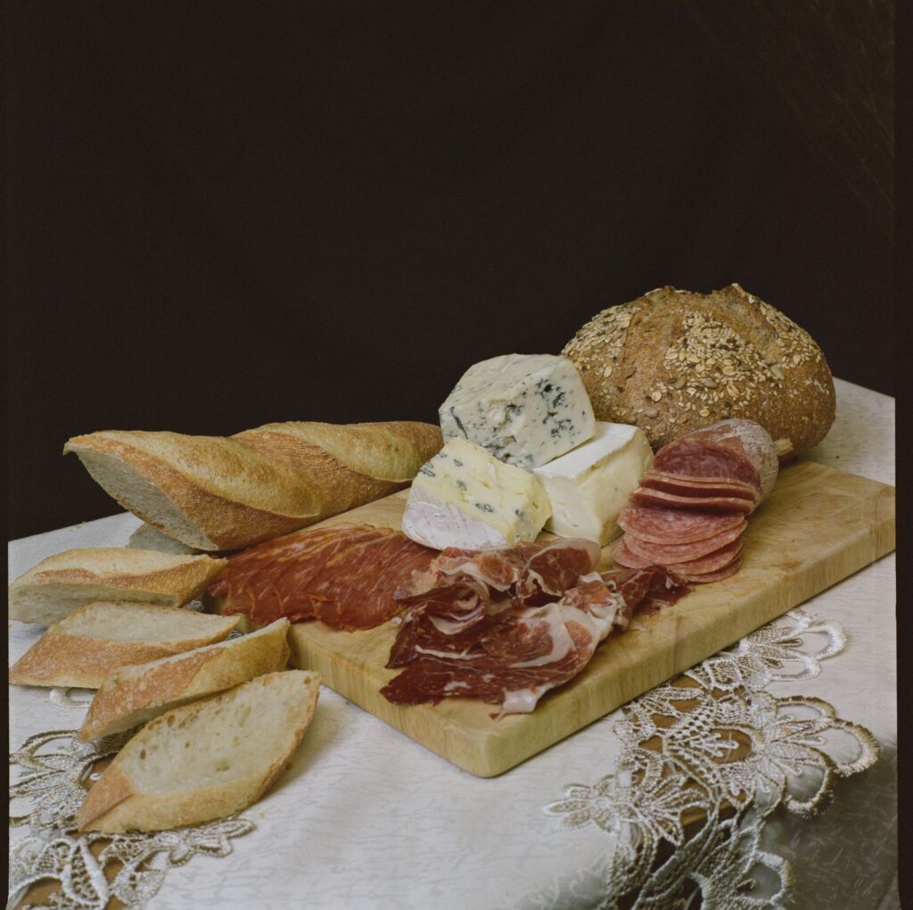 Rustic cheese board with artisan bread, cheeses and fruit