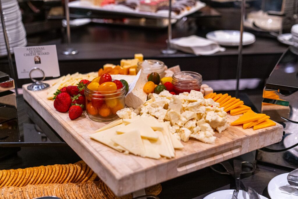 Gourmet artisan cheese board with assorted cheeses and fruit