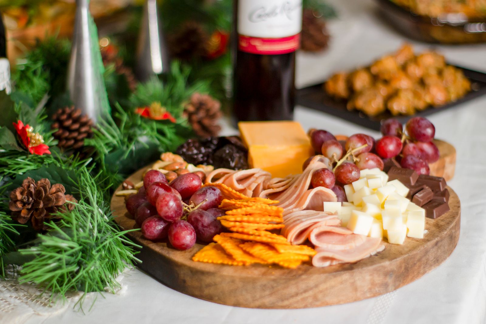 Charcuterie board with assorted cheeses, cured meats and grapes