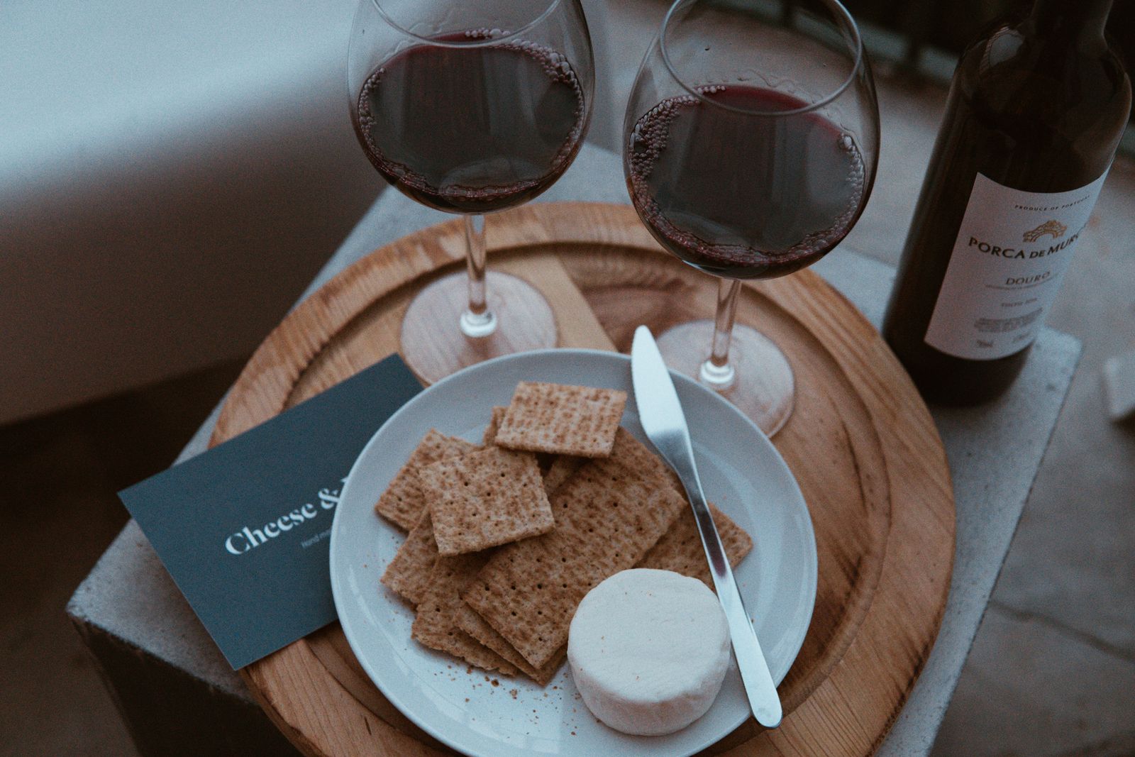 Red wine and cheese on a rustic platter