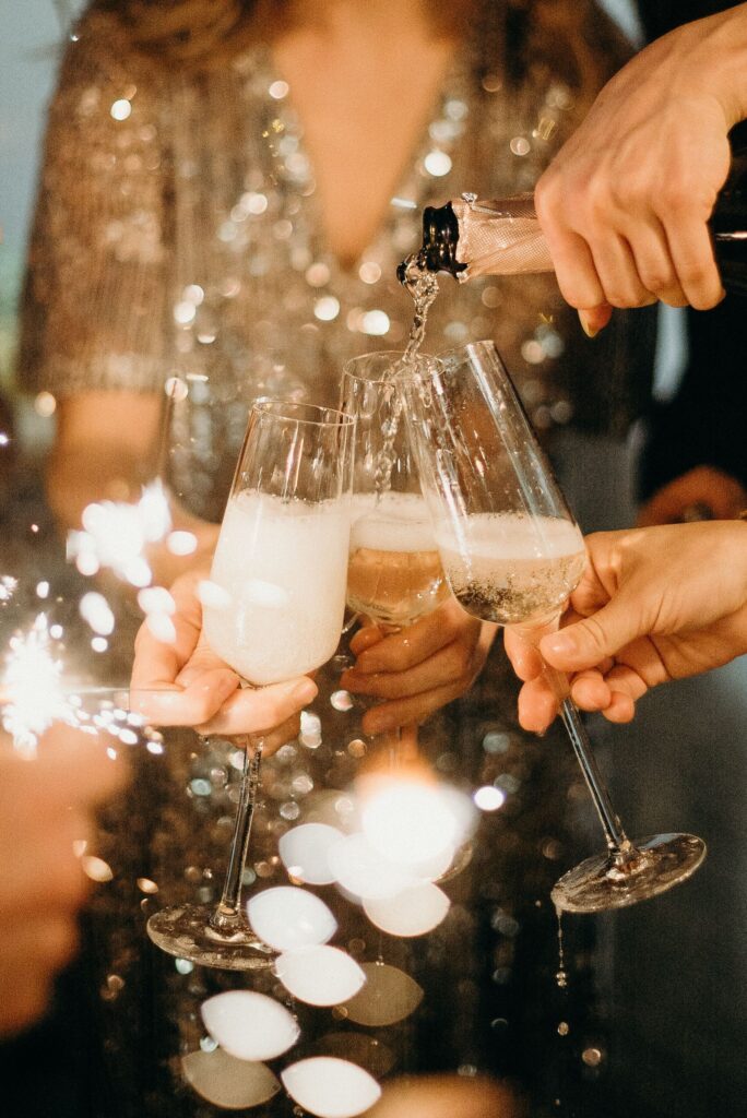 Friends toasting with Champagne glasses and sparklers on New Year's Eve