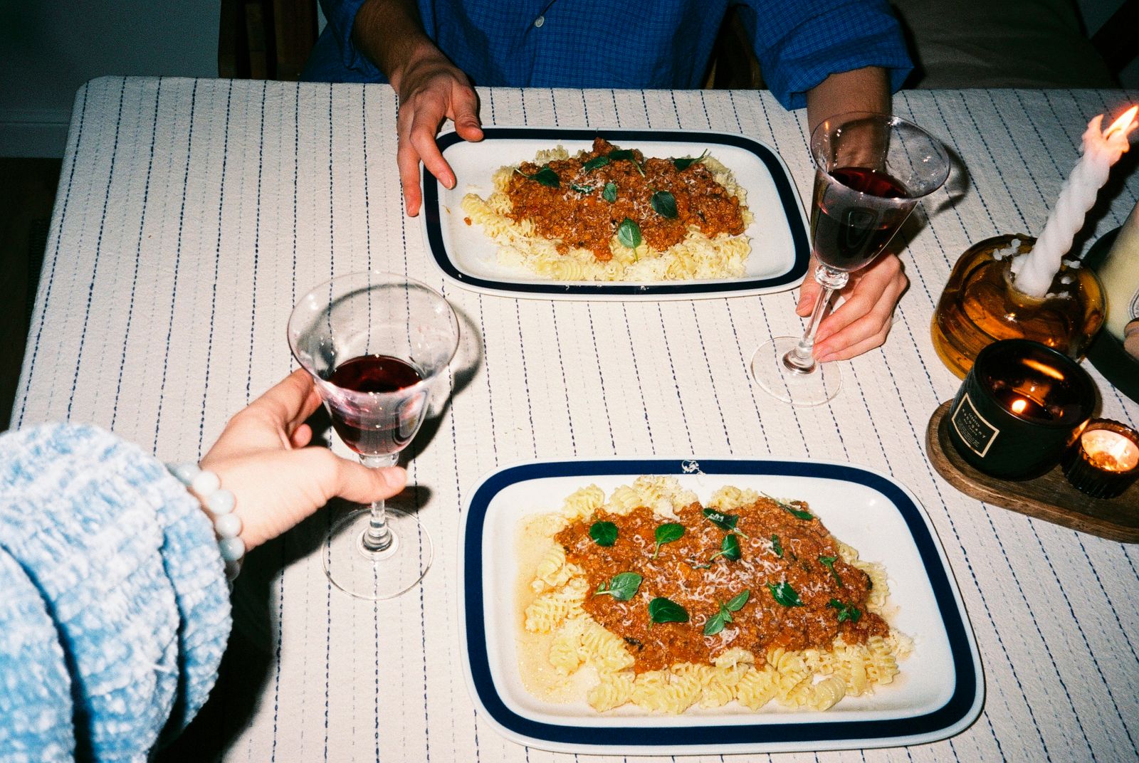Pasta dinner with red wine by candlelight