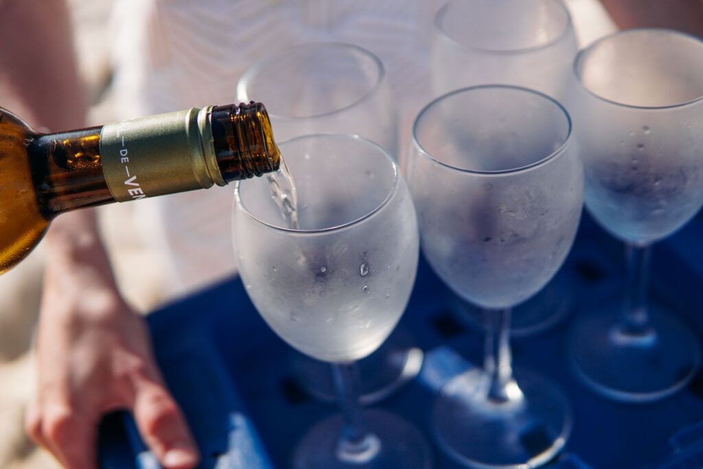 Chilled white wine being poured into glasses